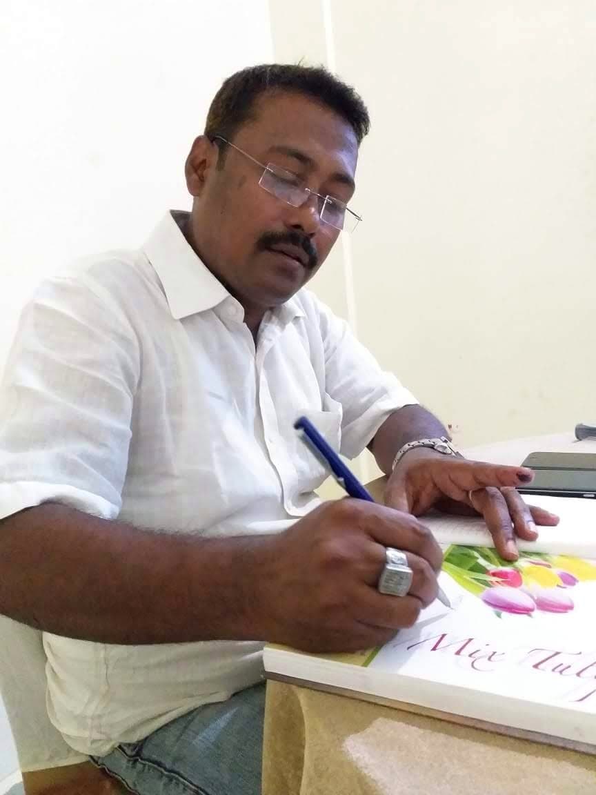 An IIES team member reviewing programme material at the organisation office