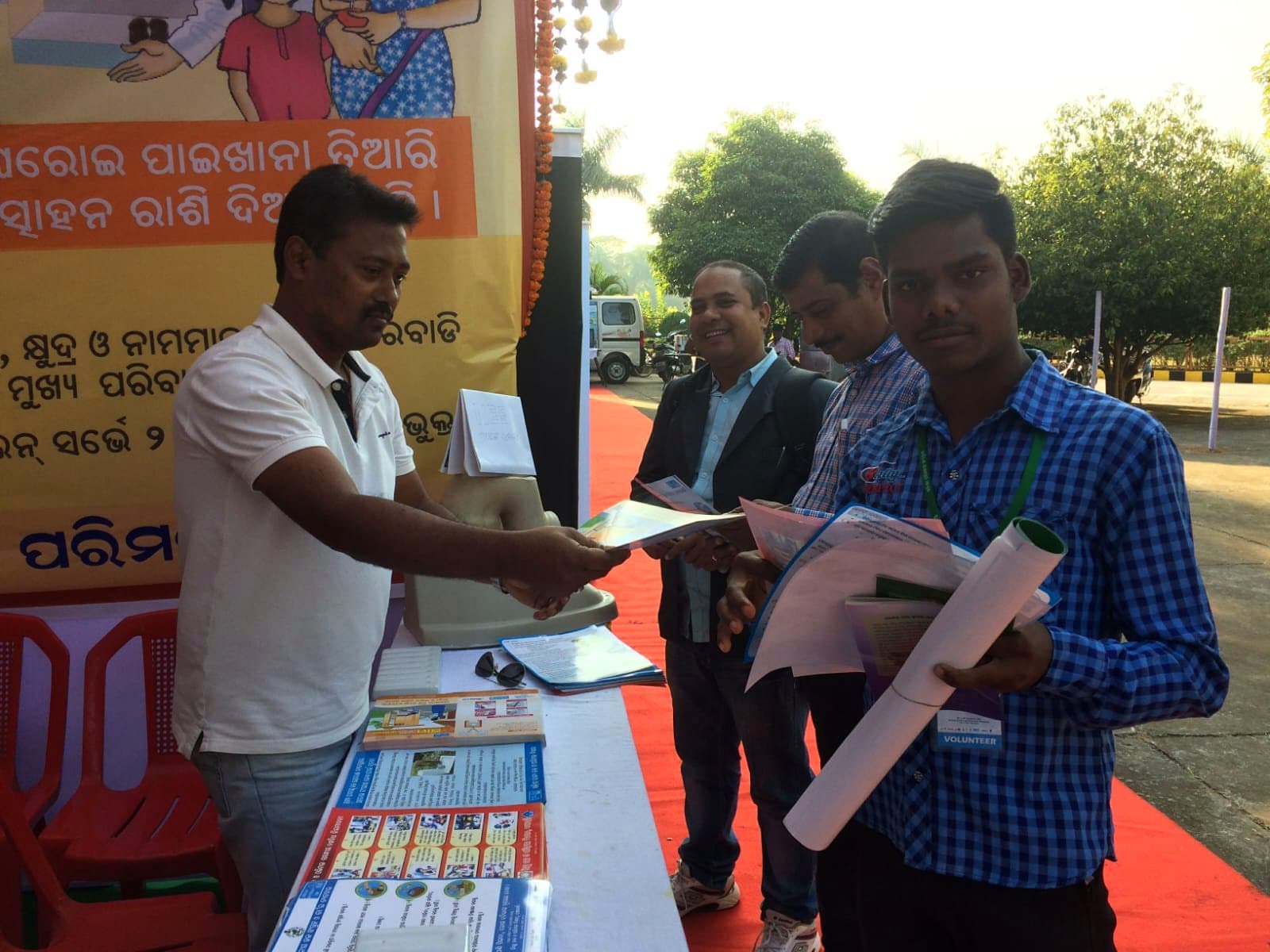 IIES field staff distributing sanitation awareness material